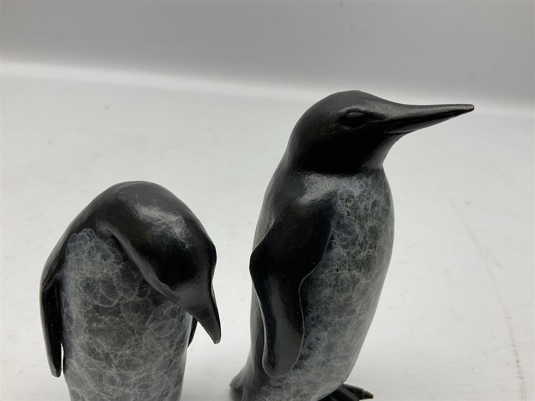 Steve Boss (British 1970-); Bronze figure group of a family of Emperor penguins, entitled Waddle, all with artists monogram beneath, tallest H12cm