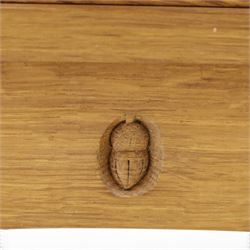 Acorn Industries - oak floor-standing corner cabinet, the top fitted with astragal glazed door enclosing four shaped shelves, the base with single panelled cupboard over two drawers, raised on four stepped feet, carved with acorn signature to top and base, by Alan Grainger, Brandsby