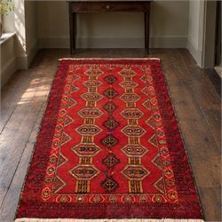 Persian Baluchi crimson ground rug, decorated with three columns of geomtric motifs