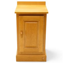 Unicornman - craftsman made oak bedside cupboard, raised back over panelled cupboard, on skirted base applied with carved unicorn signature, by Geoff Gell of Coxwold