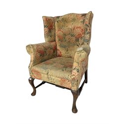 Early 20th century Georgian style wingback armchair, upholstered in floral fabric with sprung seat, walnut frame with front cabriole supports