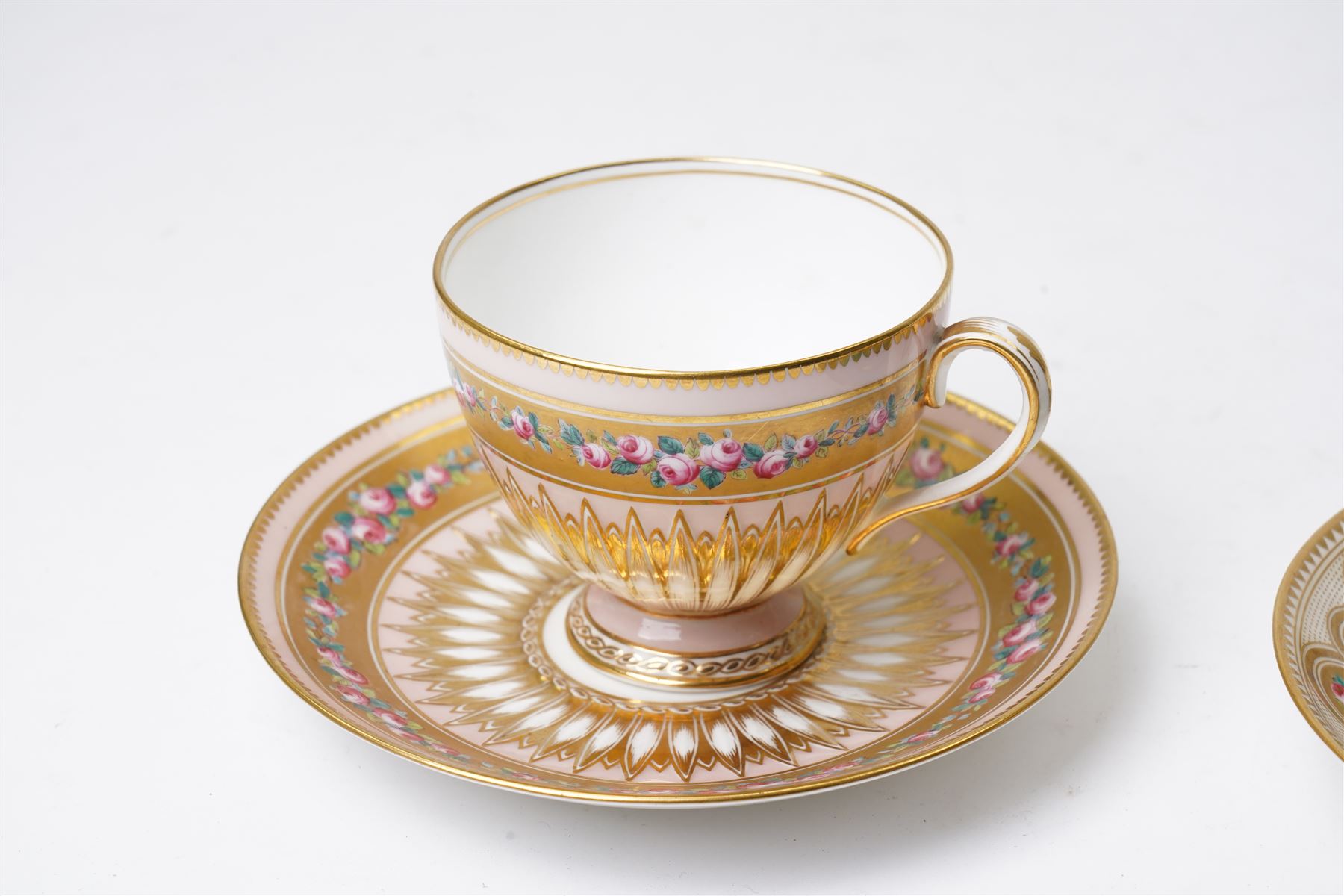 Brown-Westhead, Moore & Co cabinet cup and saucer, with rope twist moulded handle, hand-painted with floral reserves against a white and sky blue ground, heightened profusely with gilt, together with a pink hand-painted example, and a 19th century spill vase and twin-handled covered sucrier (4)