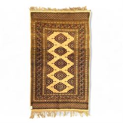 Baluchi hand-knotted wool rug, central row of stepped diamond medallions on an ivory groun...