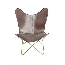 Butterfly chair, gold painted metal frame, dark tan leather slung seat 

