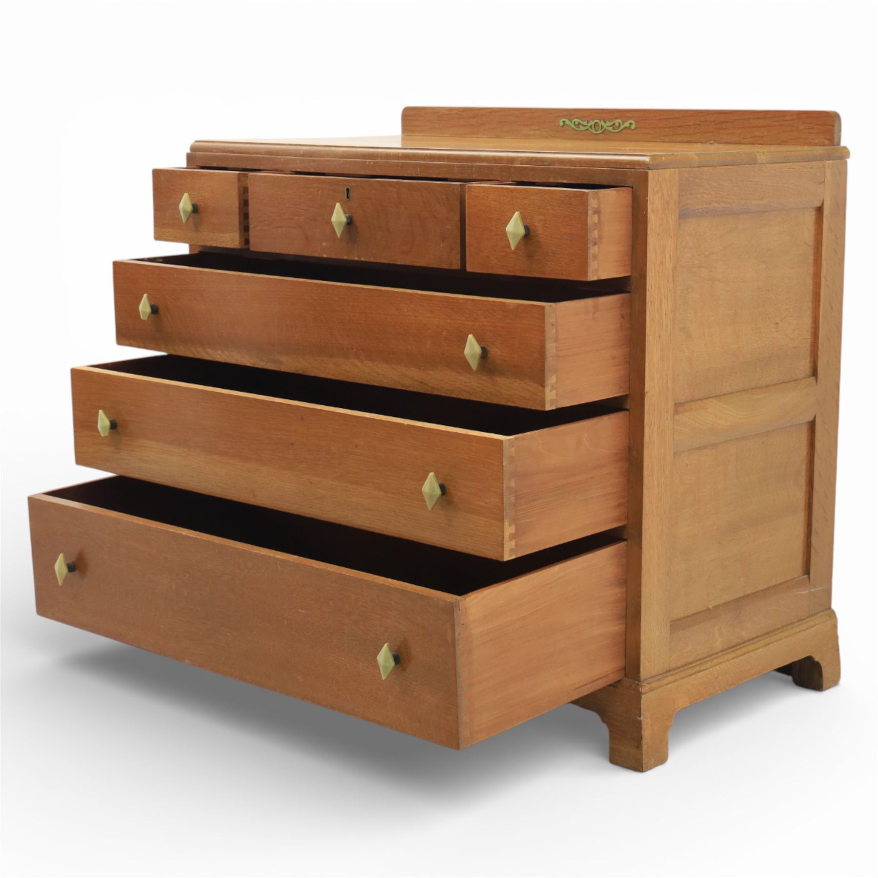 Early 20th century Art Deco bedroom suite, comprising double wardrobe, dressing table and chest of drawers, constructed in walnut with figured veneers and geometric banding, the wardrobe with arched top and panelled doors enclosing a fitted interior, the dressing table with rectangular top below a three panel mirror arrangement, fitted with two short over two long drawers, the chest with three short and three long drawers, each piece fitted with faceted handles and raised on shaped feet
Wardrobe (H 177cm, D 46cm, W 112cm)
Chest (H 85cm, D 48cm, W 92cm)
Dressing table (H 160cm, D 52cm, W 106cm)
