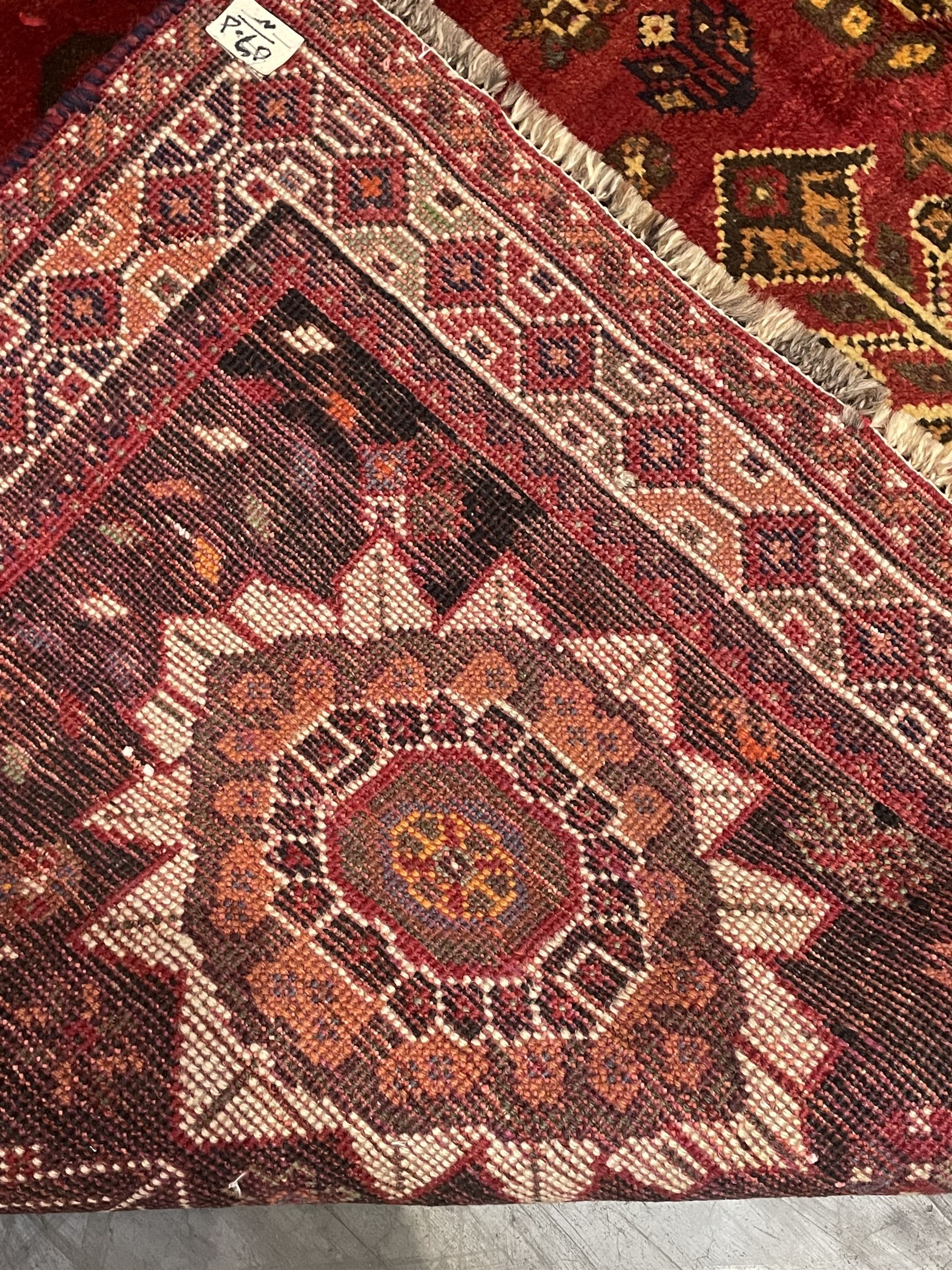Persian Azerbaijani rug, red ground field with central stylised flower