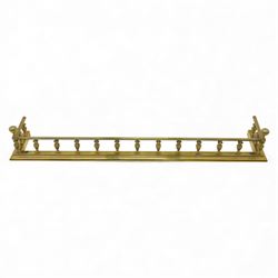 Edwardian brass fire kerb, with reeded and stepped base supporting baluster uprights and reeded top 