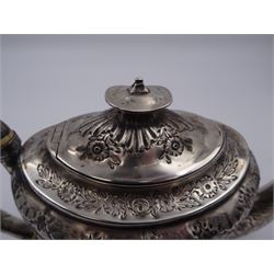 George III silver teapot, of oval form, with embossed foliate, floral and scroll decoration and engraved central cartouche, with acanthus capped C handle with ivory insulators, hallmarked John Emes, London 1807 This item has been registered for sale under Section 10 of the APHA Ivory Act
