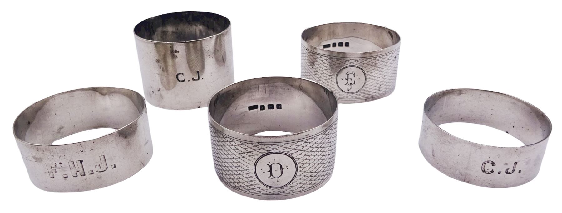 Five silver napkin rings, each of circular form, two examples with engine turned decoration, one Victorian example hallmarked Robert Thornton Birmingham 1869, a pair of Edwardian examples hallmarked T H Hazlewood & Co, Birmingham 1917, etc., approximate total weight 4.16 ozt (129.4 grams)

