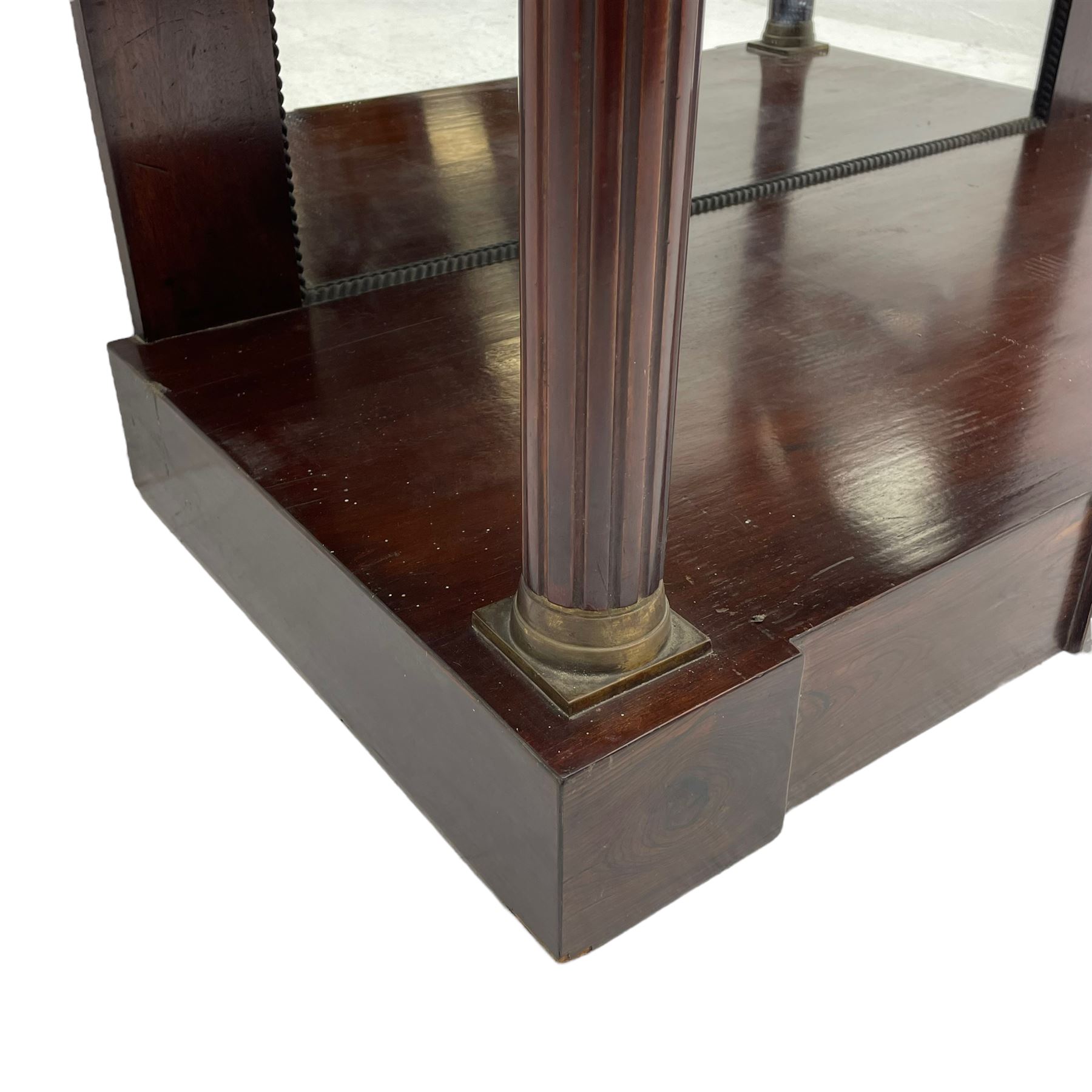 Late 19th century mahogany console or pier table, rectangular green marble top over a break-front frieze inlaid with brass scroll work panels, reed and ribbon gilt metal and wooden beaded applied mouldings, on turned and fluted front supports, plain mirror back over plinth platform base