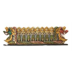 Eastern carved and painted wood plaque, depicting eight figures standing upon a boat with dragons head to each end, L100cm