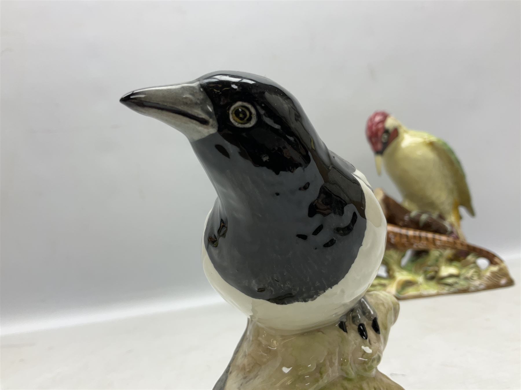 Three Beswick figures of birds, comprising pheasant no 1225, magpie no 2305 and woodpecker 1218, all with impressed marks beneath, tallest H22cm