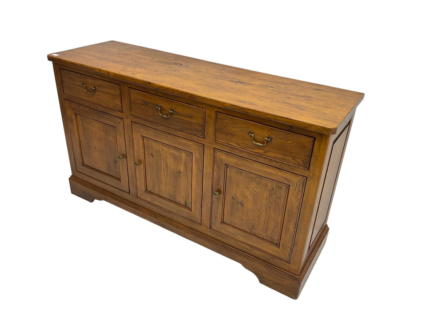 Willis & Gambier - oak sideboard, three drawers over three panelled cupboards, on bracket feet 