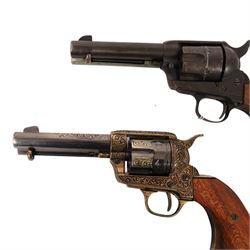 Two replica colts, each with a leather holster 