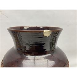 Pair of Bay West German vases, with bold moulded flower and foliage decoration in green, orange and ochre on brown ground, largest H40cm