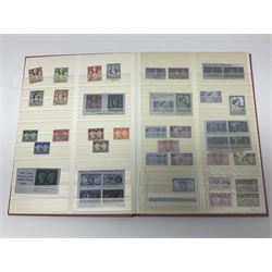 Mostly Great British stamps, including King Edward VII two shillings and sixpence, five shillings and ten shillings, King George V seahorses, King George VI high values, Queen Elizabeth II pre and post decimal etc, housed in a pink stockbook 