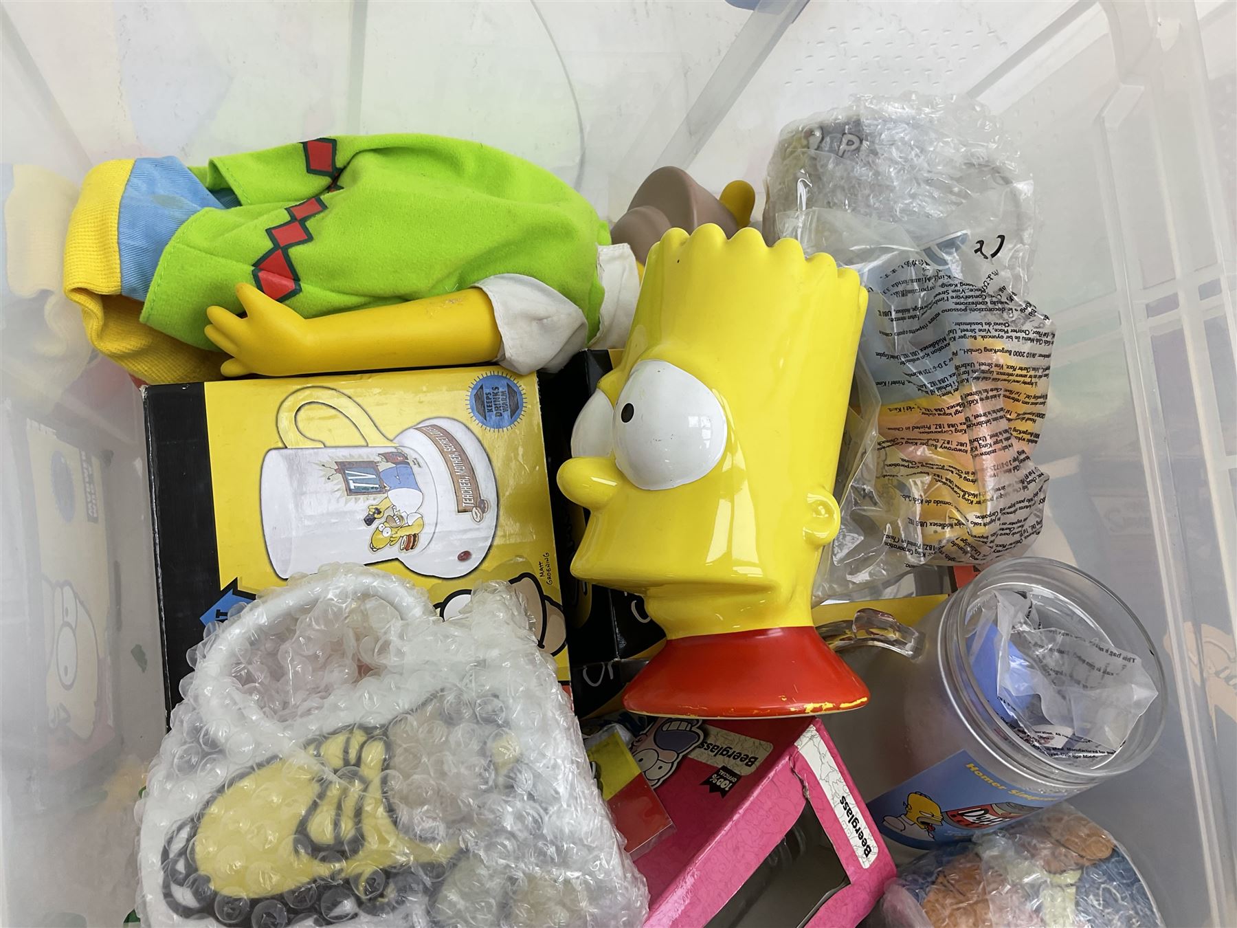 Large quantity of The Simpsons merchandise and memorabilia, to include Micro Scalextric, mugs, jigsaw, bottle openers, solar pal, glasses, etc, many boxed