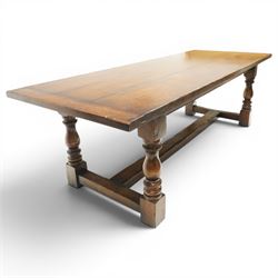 17th century design 8ft dark oak refectory dining table, the rectangular top raised on four turned baluster supports united by H-stretcher