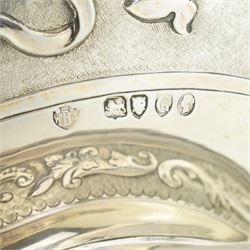 'Delwood Trophy in Memory of Col. H.H. Wilberforce' - A large Victorian silver rose bowl embossed with masks, wings, scrolls etc on a short pedestal foot D29cm London 1882 Maker Walter & John Barnard 