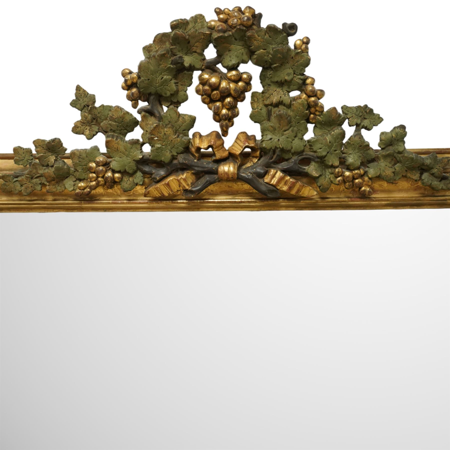 Louis XVI style gilt overmantel mirror, arched rectangular form with moulded frame, surmounted by a pediment carved with ribbon-tied grapevine and leaf decoration, enclosing a plain mirror plate, circa 1900