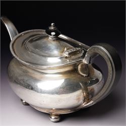Silver tea pot of oval form with ebonised handle and lift on compressed bun feet Sheffield 1919 Maker Atkin Bros.
