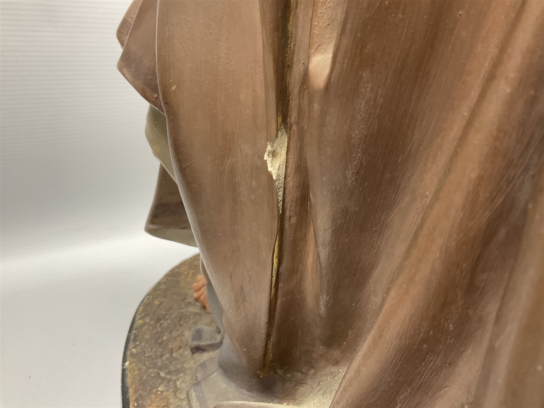 Two religious painted plaster figures of Mary and Joseph kneeling on oval plinths, with impressed mark 'Raffl et Cie Paris', H60cm 