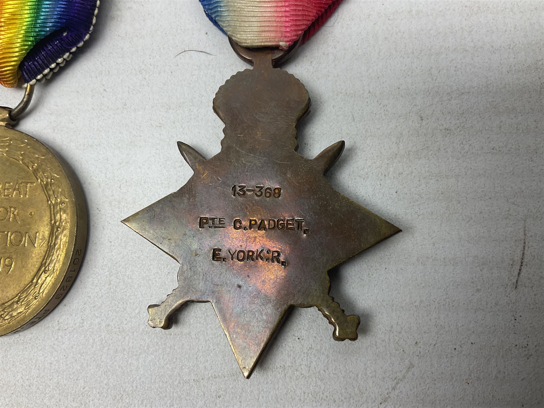 Family group of five WW1 medals for the East Yorkshire regiment comprising trio of 1914-15 Star, British War Medal and Victory medal awarded to 13-368 Pte. C. Padget; and British War Medal and Victory Medal to 201829 Pte. H.W. Padget; all with ribbons (5)