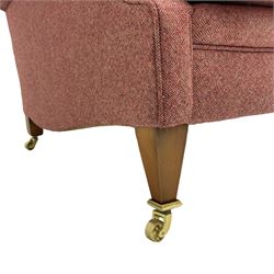 Edwardian design armchair, upholstered in wool herringbone rouge fabric, rolled arms, on square tapering supports with brass castors
