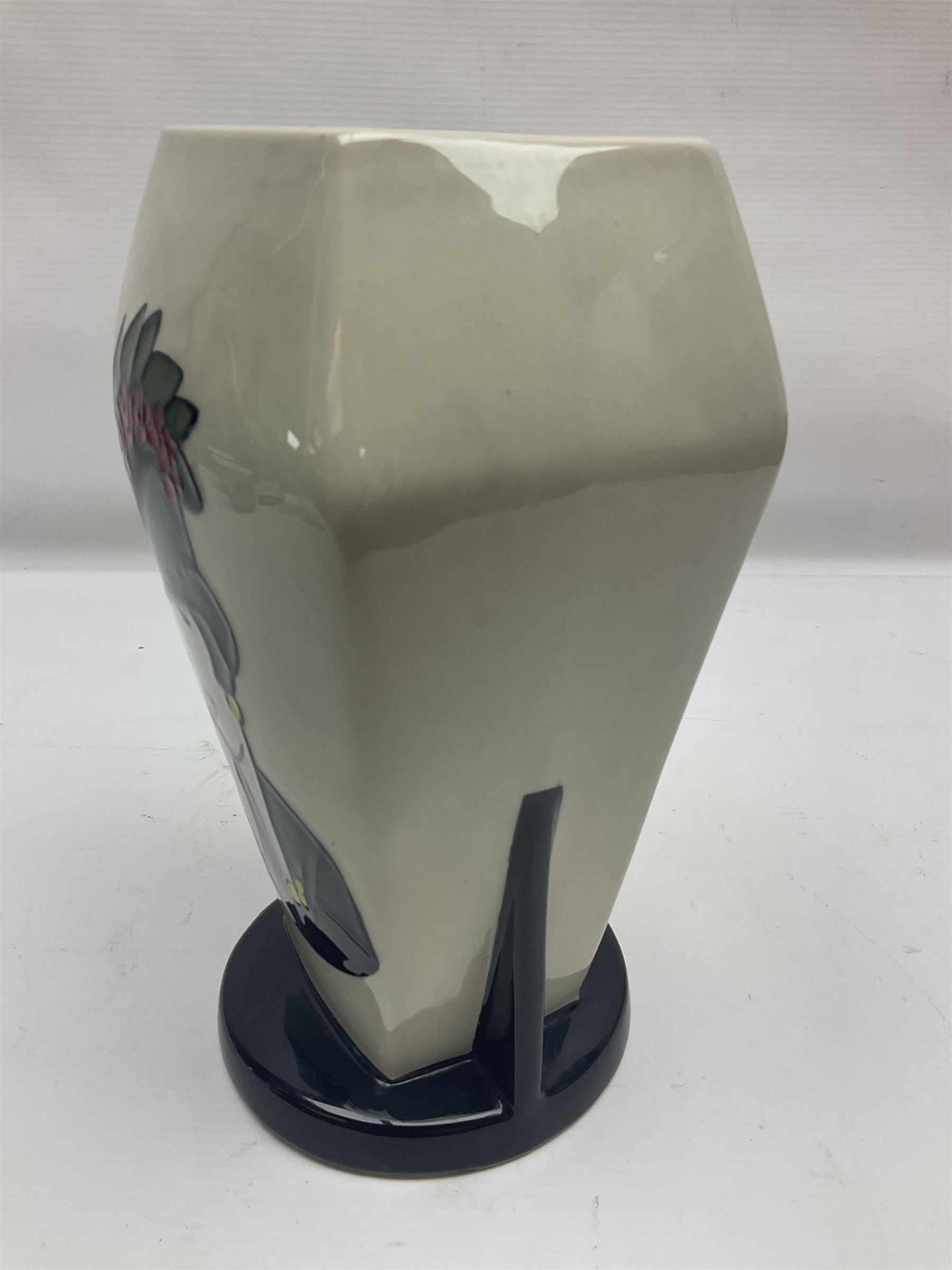 Charlotte Rhead for Crown Ducal ceramics, comprising coffin shaped vase depicting a woman in 1920s dress, a vase with handle, decorated with autumn leaves and a bowl, decorated with flowers and berries, with printed and signed marks beneath, coffin vase H24cm