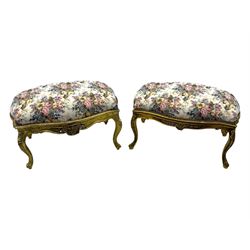 Pair of Louis XV-design giltwood stools, each upholstered in floral tapestry fabric, the carved frame adorned with scrolling foliage and shell motifs, raised on cabriole supports