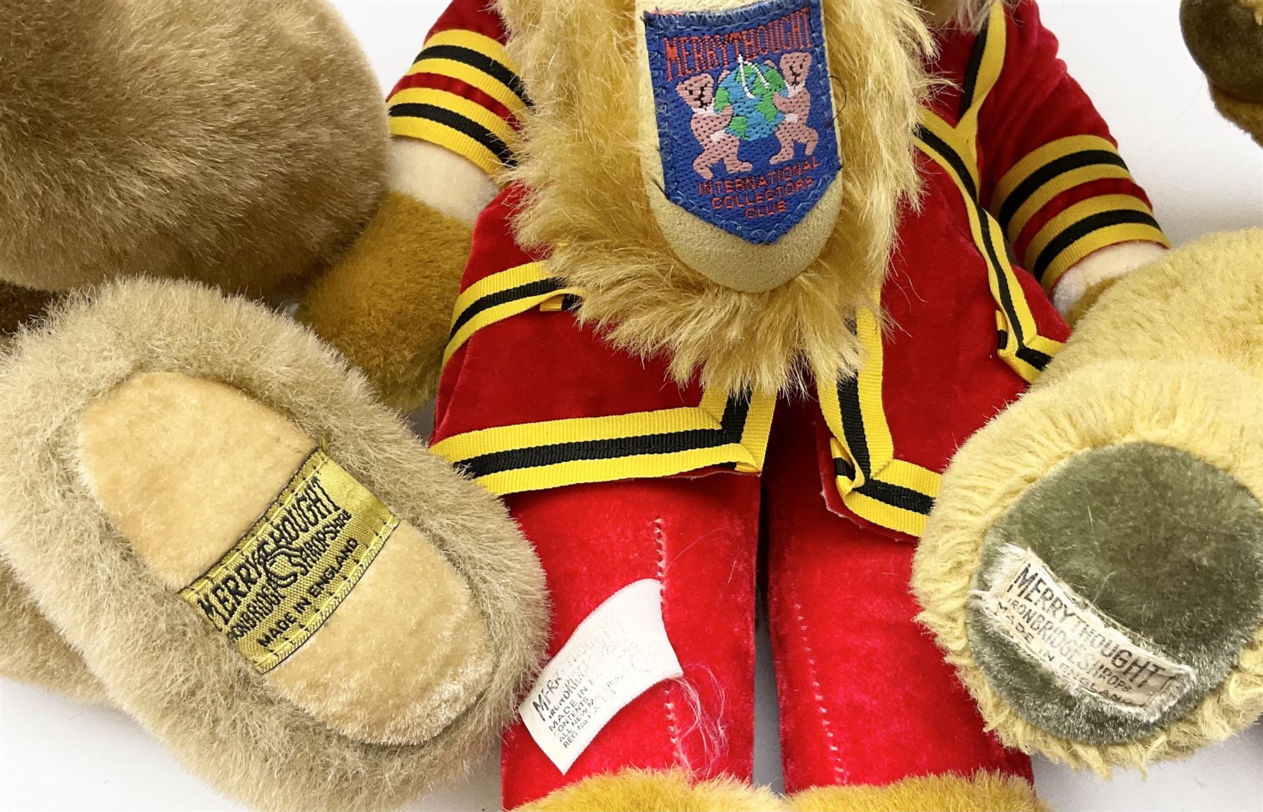 Four Merrythought teddy bears - International Collectors Club limited edition with growler mechanism No.71; plain brown with back-wind musical movement; golden brown dressed as a Beefeater; and earlier light golden coloured (4)