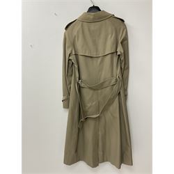 A ladies Burberry trench coat, with waist belt and check lining, no size label, measures approximately arm pit to arm pit L51cm, H117cm