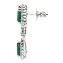 Pair of 18ct white gold emerald and diamond pendant stud earrings, the two clusters separated by a single round brilliant cut diamond, stamped, total emerald weight approx 5.80 carat, total diamond weight approx 2.45 carat