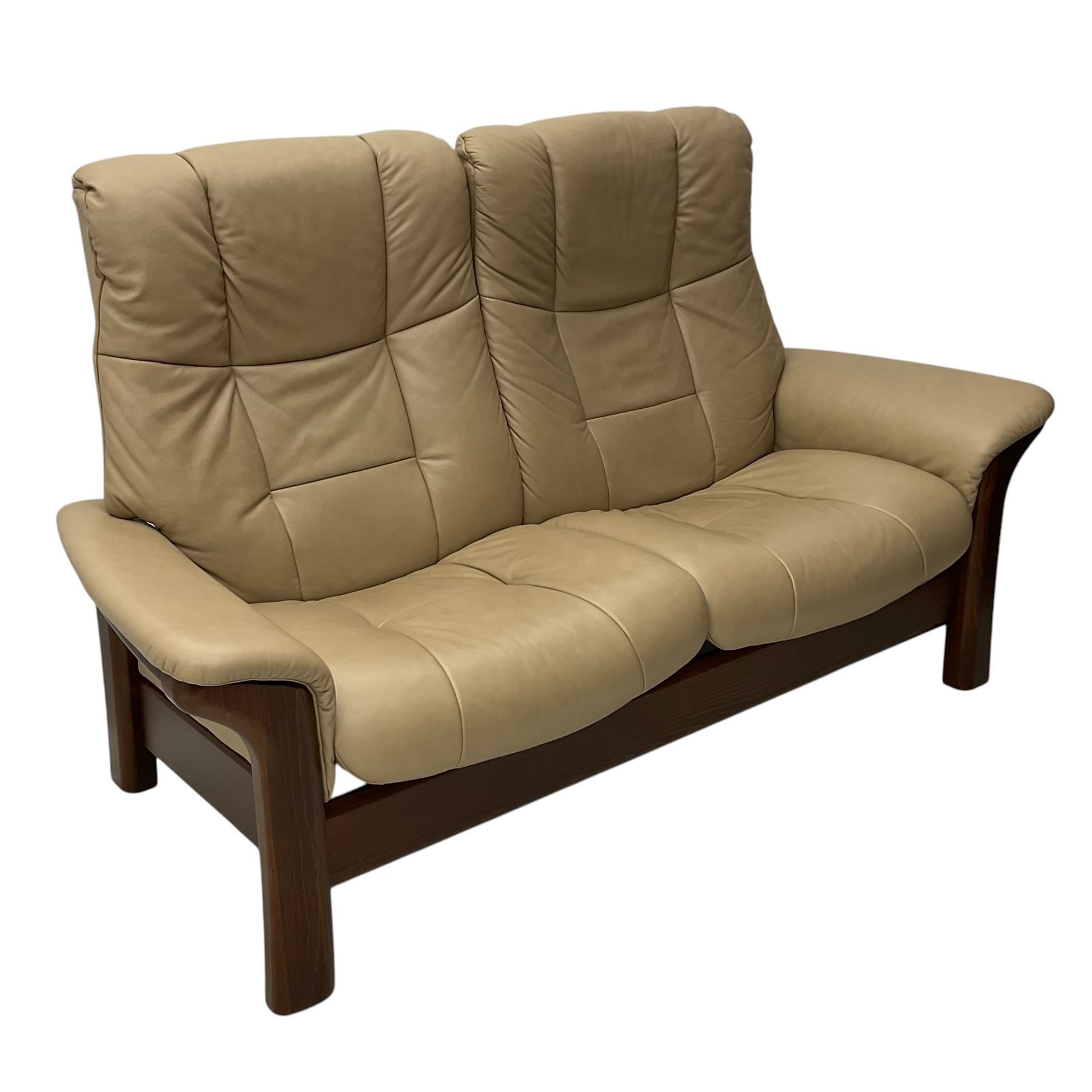 Ekornes Stressless - two-seat beech framed sofa, upholstered in beige-brown leather with stitched panel detailing, featuring curved armrests and high back supports with manual recline mechanism, raised on a dark-stained beech frame with sculpted supports