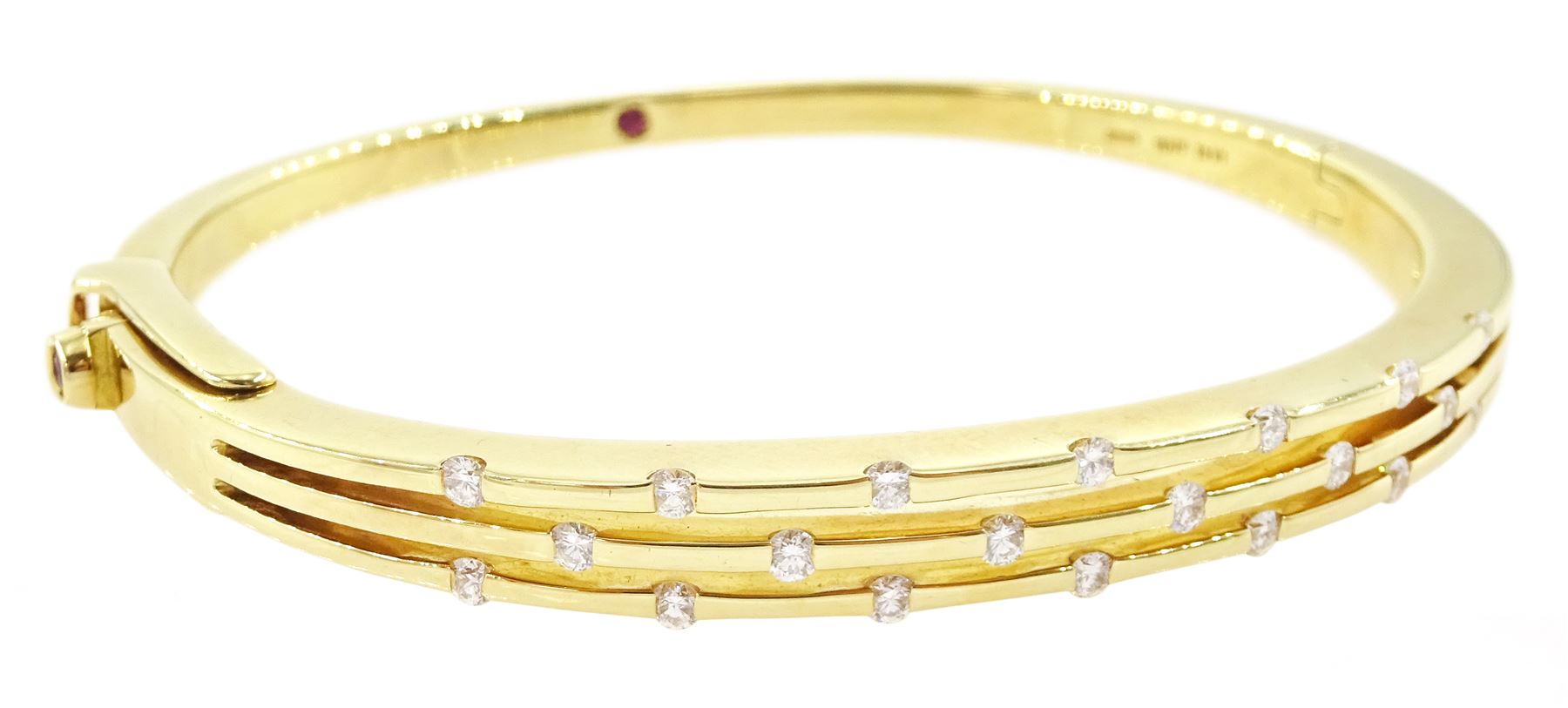 Roberto Coin 'Parisienne' 18ct gold three row round brilliant cut diamond bangle, with a signature round cut ruby to the underside and ruby set clasp, Birmingham 2006, boxed
