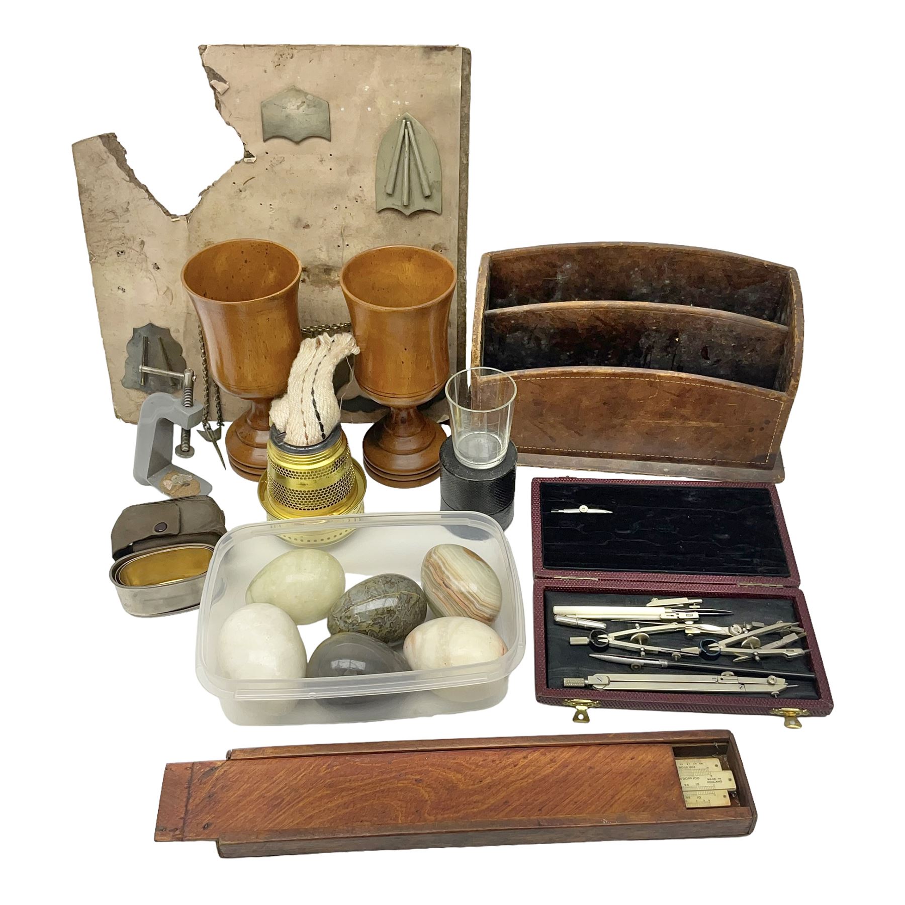 Pair of turned wooden goblets, six hardstone eggs, vintage slide rule and a leather letter rack, etc