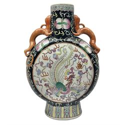 20th century Chinese moon flask, with twin lizard handles, the body with floral and foliate decoration in polychrome enamels upon a black ground, bordering a central panel depicting a phoenix chasing a flaming pearl amongst clouds upon a white ground, with six character marks for Guangxu beneath, H35.5cm 