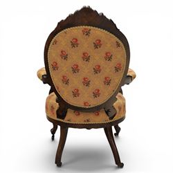 Victorian mahogany open armchair, oval stuff-over back with floral upholstery, moulded and foliate carved frame with pierced crest, padded open arms with scroll terminals, serpentine seat rail on cabriole supports