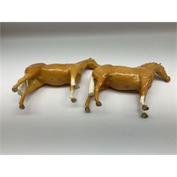 Two Beswick Palomino horse figures, comprising 'Imperial' Palomino, model no. 1557, designed by Albert Hallam and James Hayward, together with Palomino Arab model no. 1771, both stamped, tallest H20cm