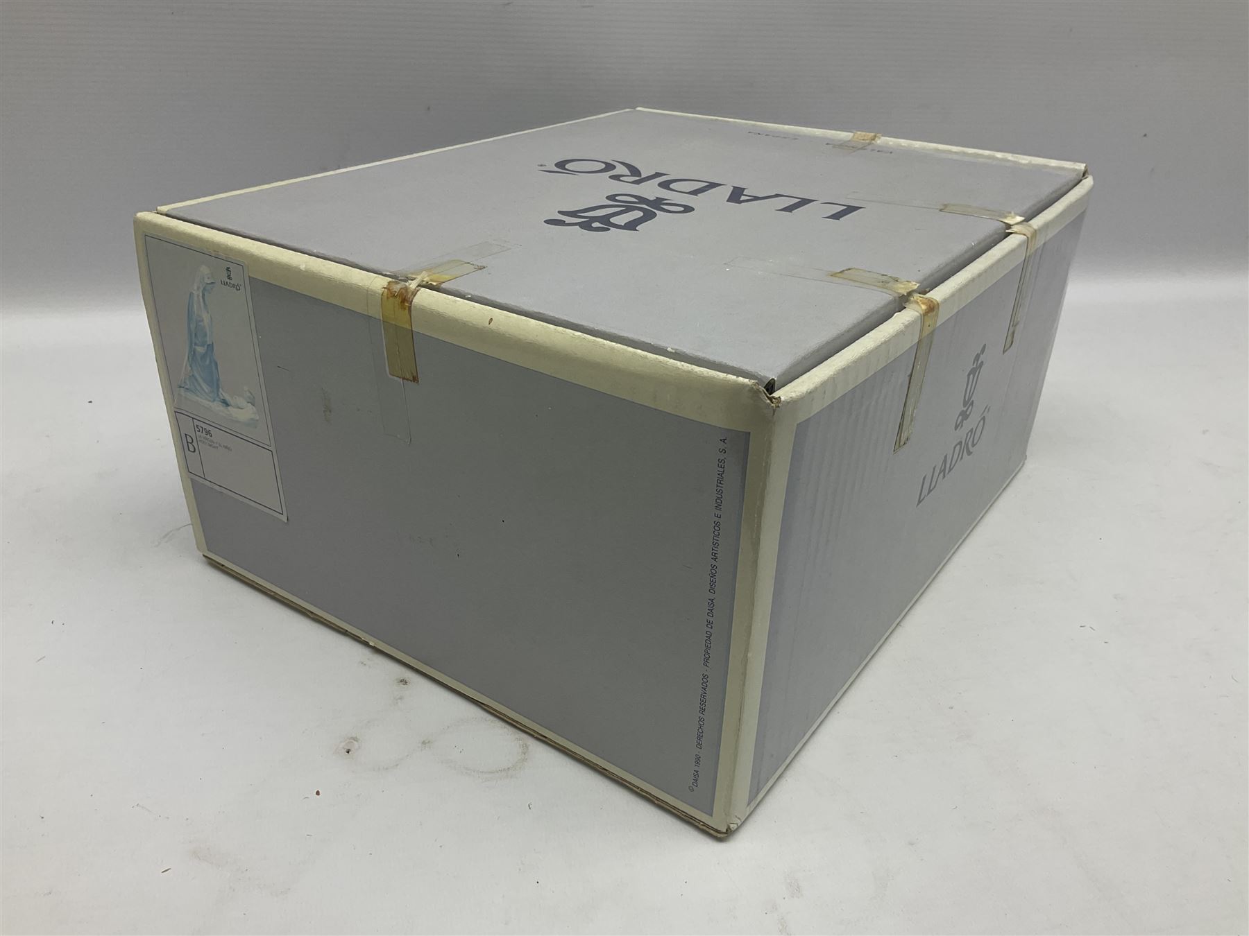 Lladro figure, Holy Night, modelled as Mary kneeling over baby Jesus, sculpted by Vincente Martinez, with original box, no 5796, year issued 1991, year retired 1994, H22cm