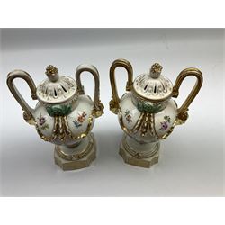 Pair of Meissen type porcelain urn shaped vases, each painted with male and female figures harvesting, pierced covers, gilt mask handles and swags, H23cm