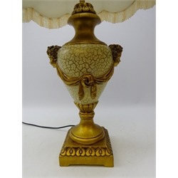  Classical style gilded baluster table lamp with cherub masks on moulded square base with fringed shade, H84cm overall   