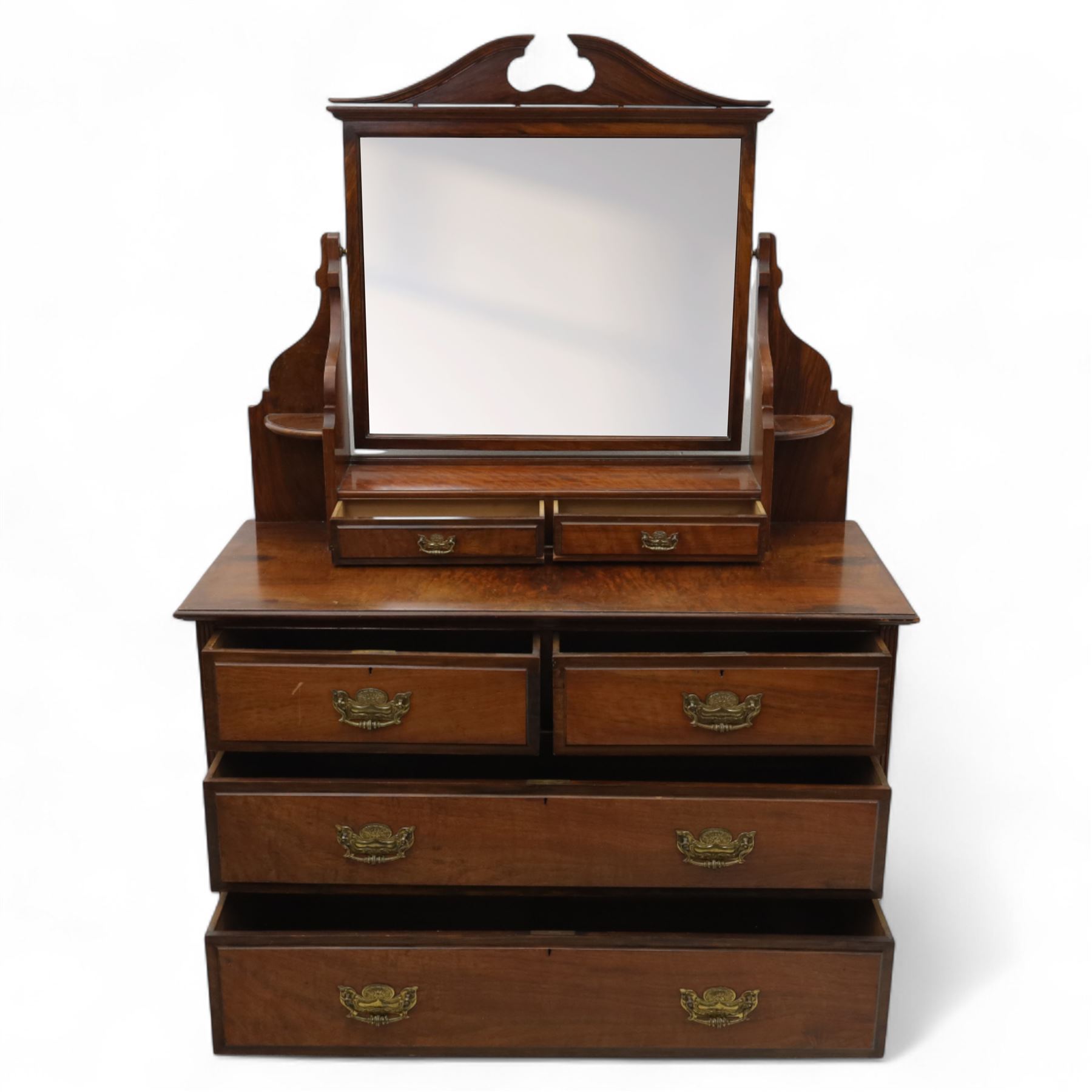 Edwardian walnut dressing chest, rectangular top surmounted by a mirror frame with shaped pediment on swing supports above two short frieze drawers over two short and three long graduated drawers fitted with brass foliate handles, raised on a plinth base