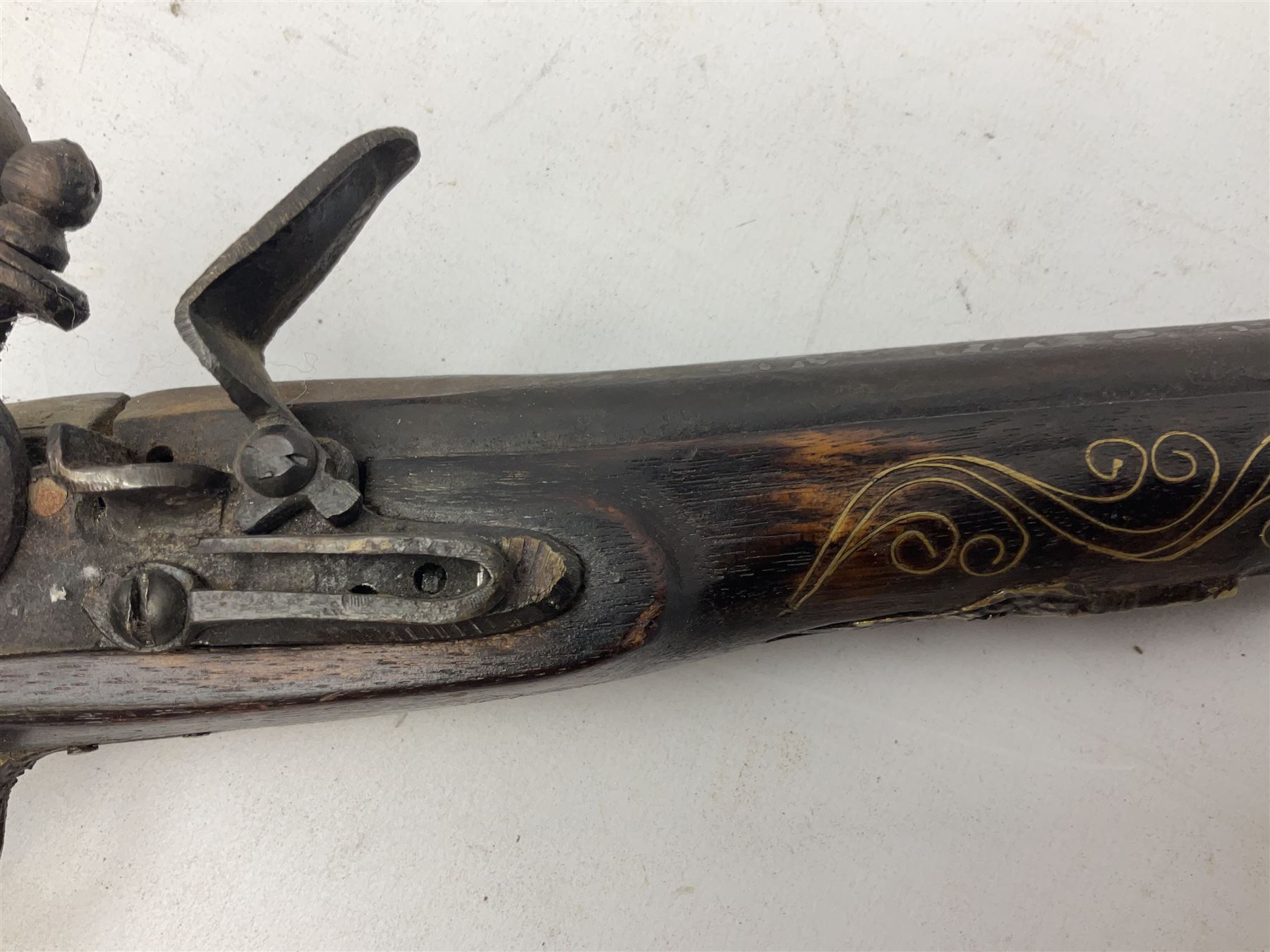 Reproduction flintlock pistol, the full walnut stock with brass filigree inlay and mounts and skull crusher butt L46cm; no visible proof marks FIREARMS CERTIFICATE REQUIRED OR RFD