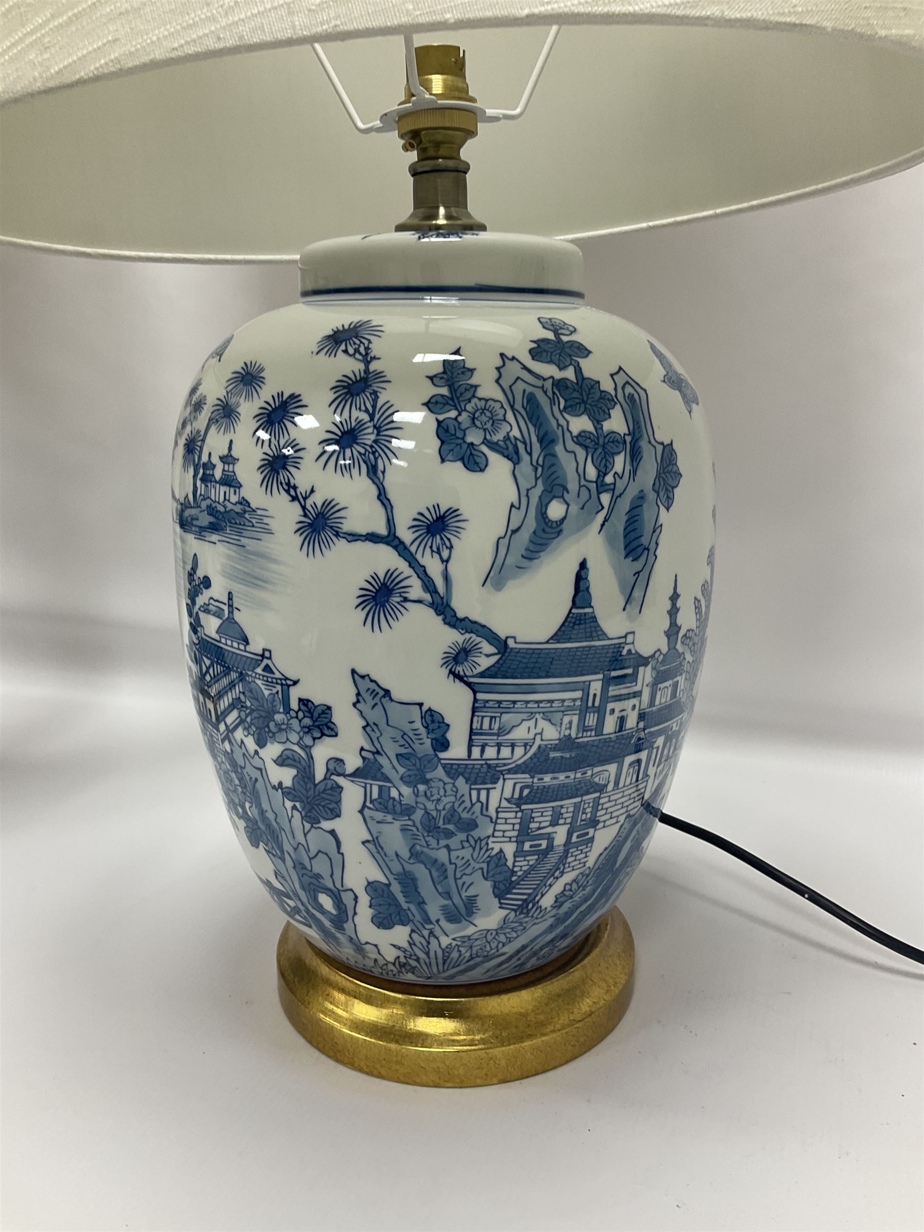Pair of Chinese table lamps of baluster form, each decorated with landscape scene, raised upon gilt circular base, including shade H63cm