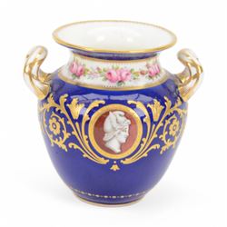 Early 20th century Minton porcelain twin handled pedestal cup, decorated with two reserve painted with birds against a blue ground, upon a square plinth painted with pink roses, the whole heighted with gilt, with puce printed mark beneath, H11.5cm, together with an early 20th century Minton twin handled vase, of ovoid form decorated with two painted portrait medallions, surrounded by gilt foliate scrolls, upon a blue ground, the neck painted with a band of pink roses, with gilt printed mark beneath, H11.5cm, and an early 20th century Minton twin handled pedestal vase and cover, painted with pink rose and vine swags upon a white ground, with puce printed mark beneath, H18.5cm, (3) 