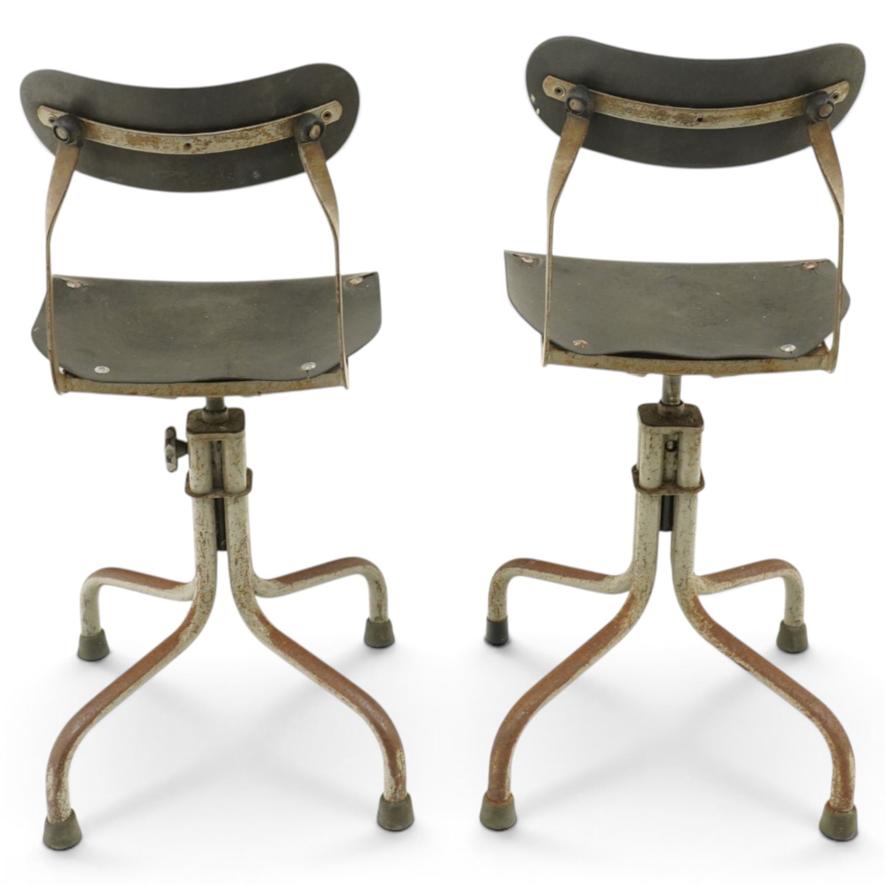 Pair of mid 20th century 'Tan-Sad' industrial chairs, black moulded fibre seats, raised on four supports