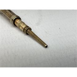 Victorian gold propelling pencil of hexagonal form decorated with foliate engraving and stone set terminal, L9cm (unmarked, tested to 7.8K)