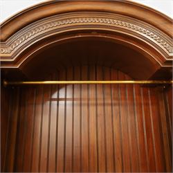 And So To Bed - French design ‘Eclectic’ double wardrobe in dark finish, arched moulded cornice with carved foliate band and turned finials, two mirrored doors enclosing a hanging rail, flanked by turned columns with foliate decoration, single fluted drawer below, on turned tapering feet