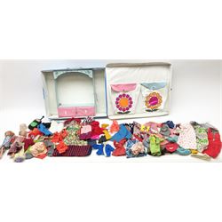 The World of Barbie Double Doll Case containing a quantity of assorted doll's clothing; together with two large and one small fashion dolls.